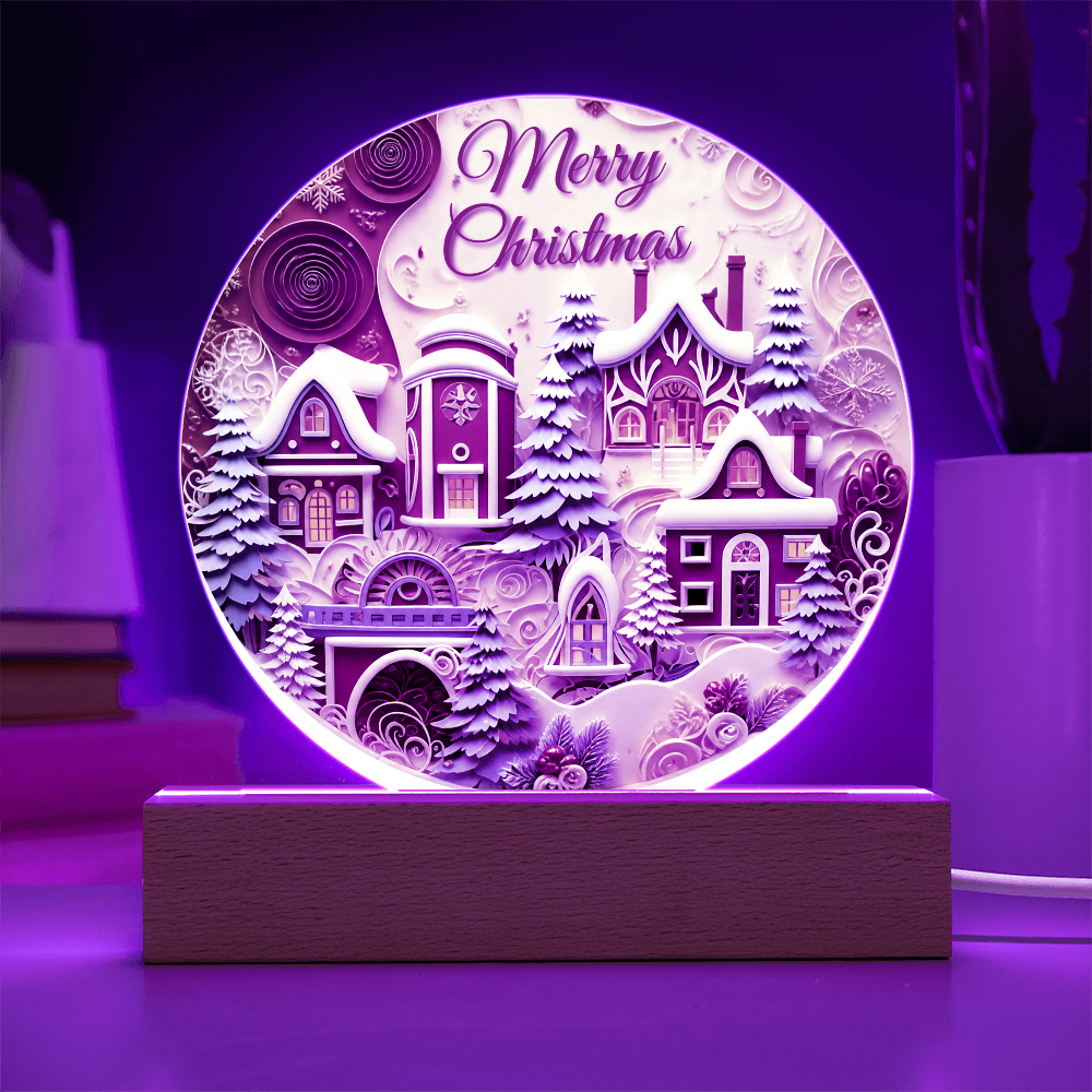 Winter House round acrylic desk plaque glowing with purple LED backlighting, featuring a snow-covered village and Merry Christmas text on a wooden base.