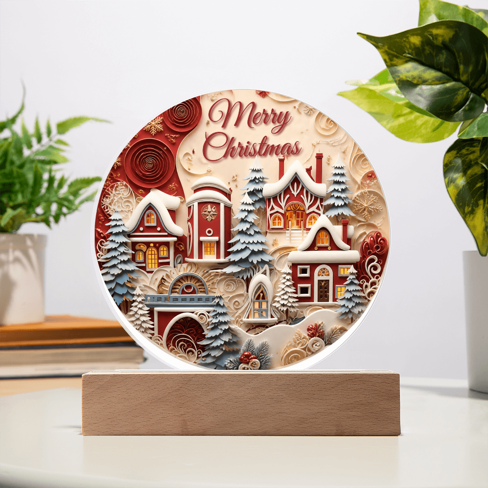 Winter House round acrylic desk plaque featuring a snow-covered village and Merry Christmas text on a wooden base.
